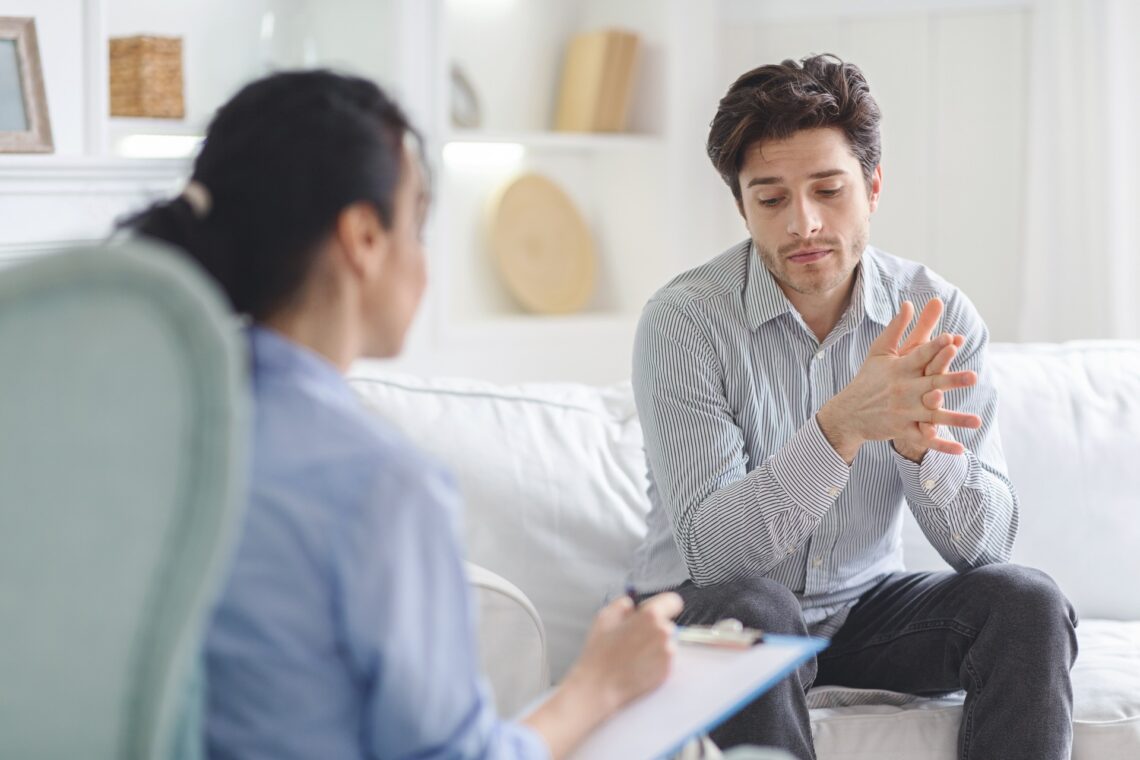 Man discussing substance use with therapist while asking is kratom an opioid.
