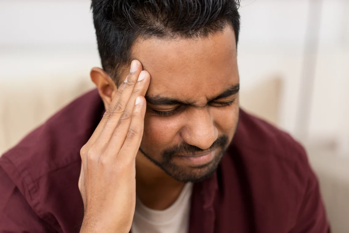 Suboxone Withdrawal Symptoms: A man holding his head in pain