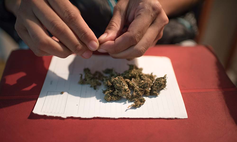 kratom placed on a white sheet of paper.